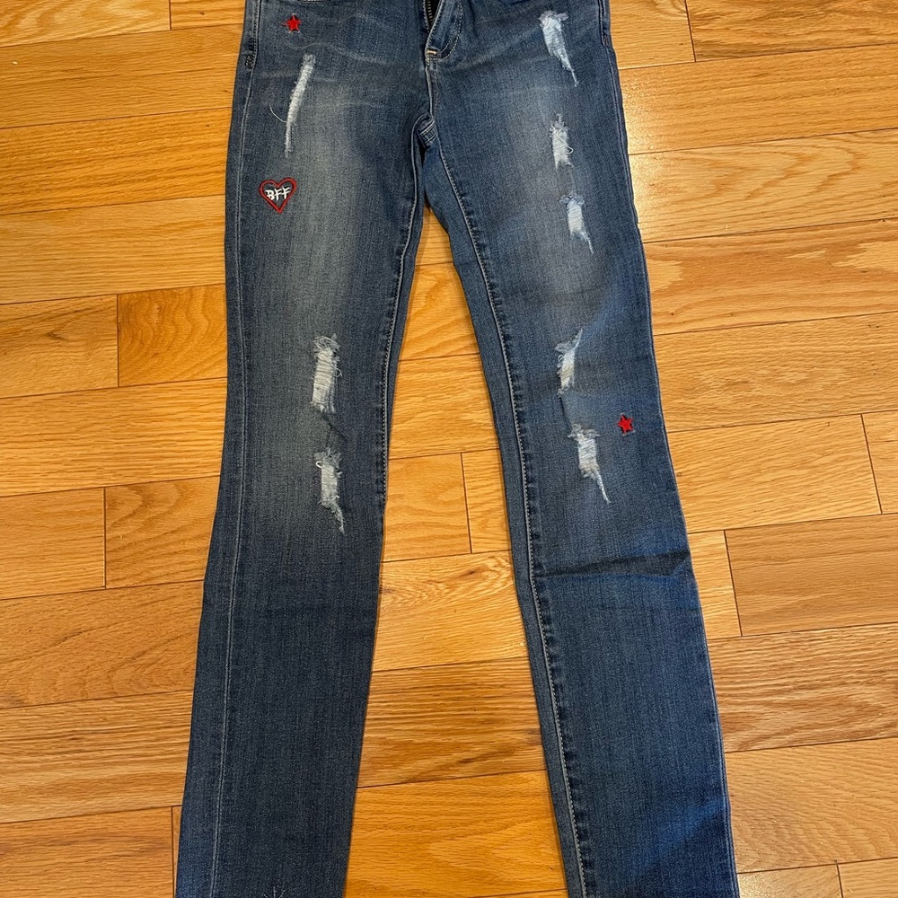 Brand new jeans for girls, with decorations on the back. Stylish